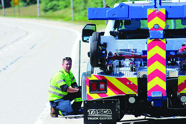 AAA worker providing roadside assistance