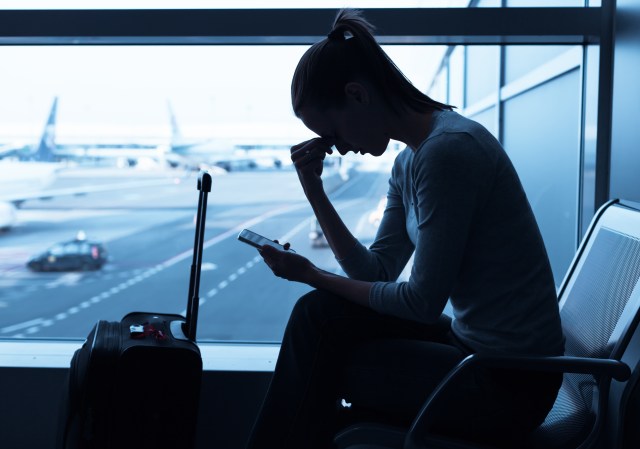 travel insurance - woman is stressed at the airport