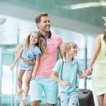 family traveling together through an airport