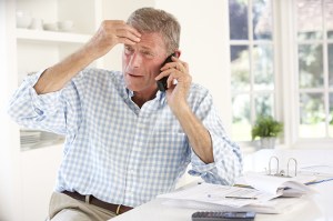 man stressed over the phone about completing a life insurance claim