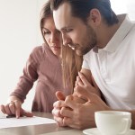 young couple reviewing their life insurance policy