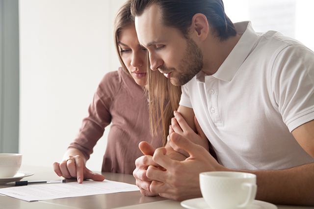 young couple reviewing their life insurance policy