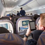 passenger on a plane checking of his travel list