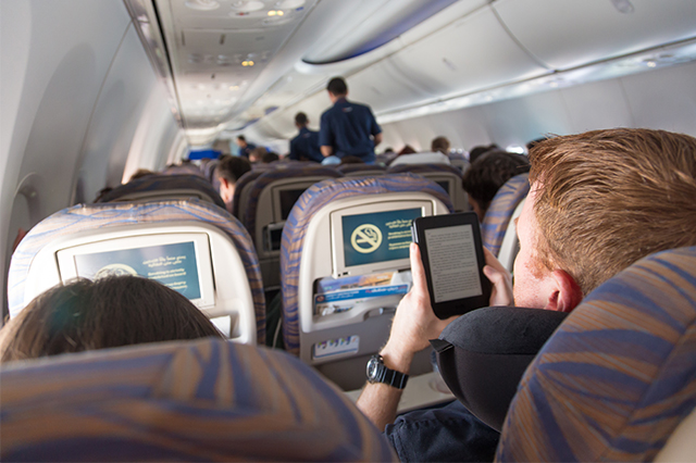 passenger on a plane checking of his travel list