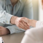 two people shaking hands in agreement