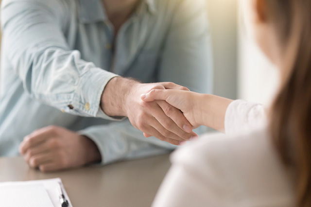 two people shaking hands in agreement