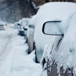 snow covered cars on the street