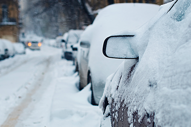 snow covered cars on the street