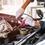 mechanic jump starting a car