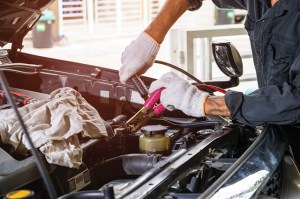 mechanic jump starting a car