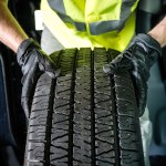 mechanic holding tire up close