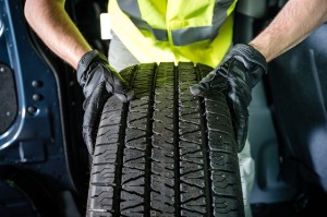 mechanic holding tire up close