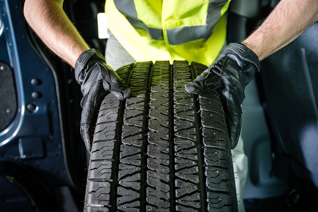 mechanic holding tire up close