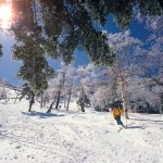 man skiing down snowy slopes