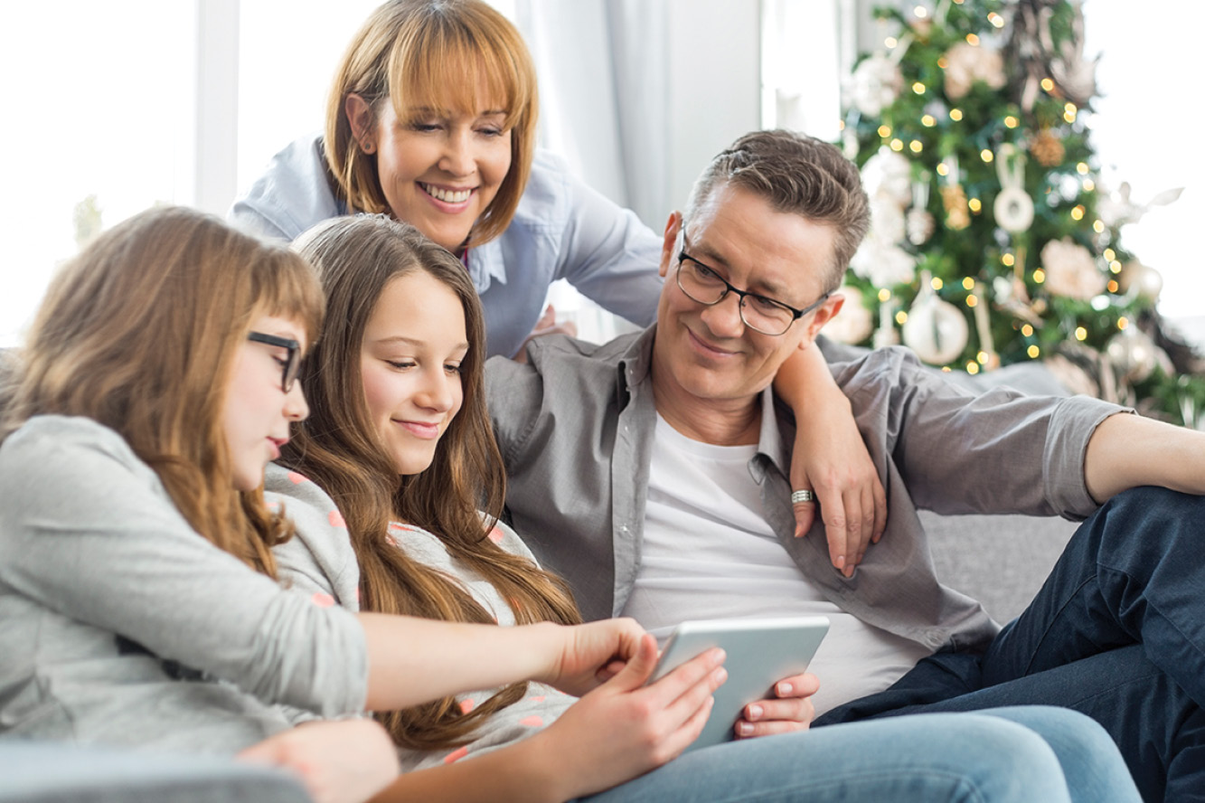 family huddled together using a tablet