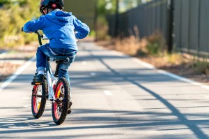 young kid riding a bike