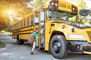 young kid boarding a school bus - when to stop for a school bus