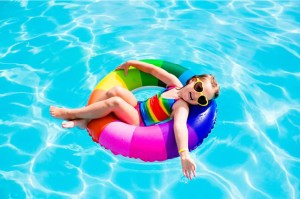 child in pool tube float