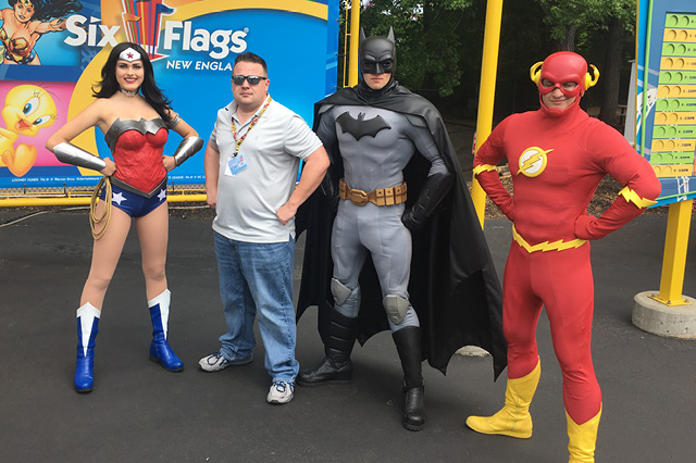 George Morse with superheroes at Six Flags New England.