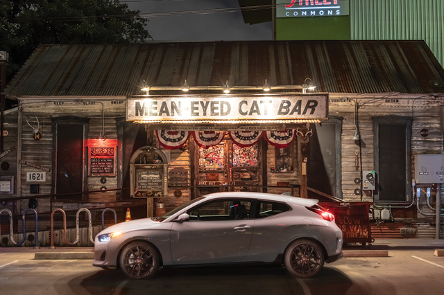 hyundai veloster parked outside a restaurant