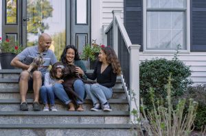 family in front of house
