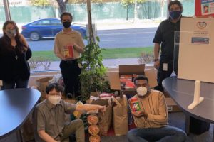 group of people hold packaged food