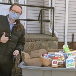 women with bin of food donations