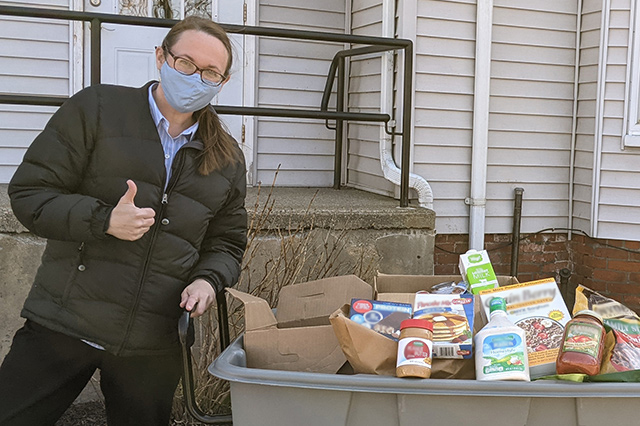 women with bin of food donations