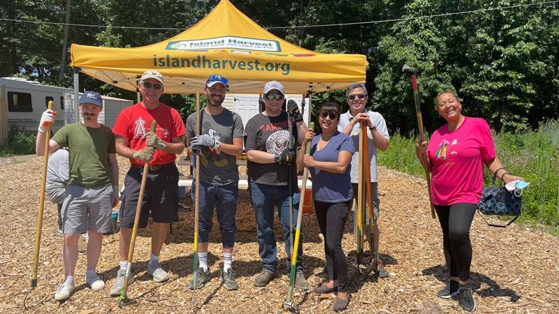 AAA employees with rakes and hoes.