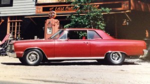 Red car amid 1960s-style backdrop