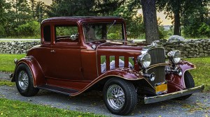 Dark red old car in park setting