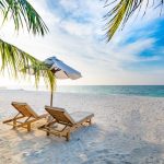 chairs on beach. sustainable beach vacation.