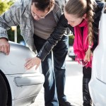 people examining car
