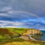 the best time to visit ireland to avoid crowds - copper coast with rainbow