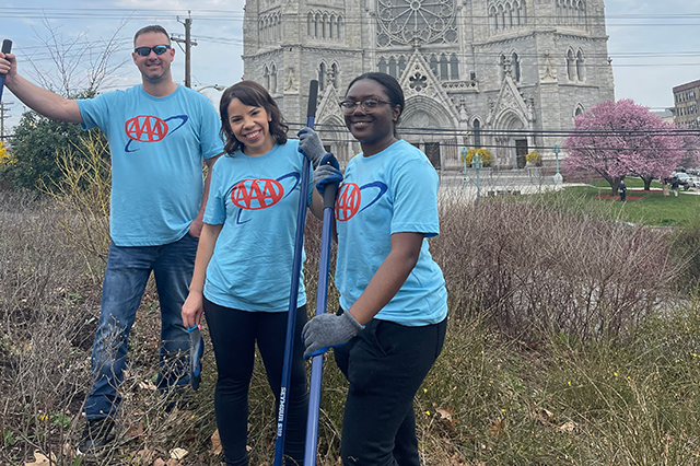 AAA employees with rakes and shovels