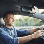 man driving a car