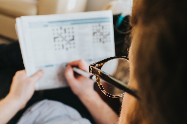 playing crossword with glasses on