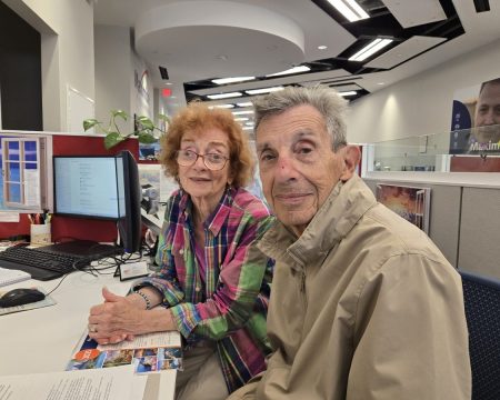 Karen and Simon Landsman finalizing trip plans at the Garden City, New York, branch.